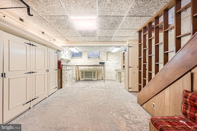 basement featuring a paneled ceiling