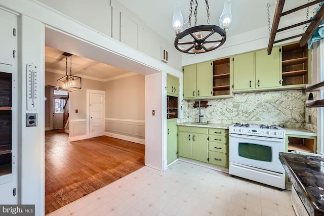 kitchen with pendant lighting, a notable chandelier, white range with gas stovetop, and green cabinets