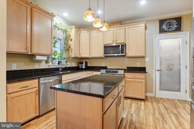 kitchen with stainless steel appliances, a kitchen island, and light brown cabinetry