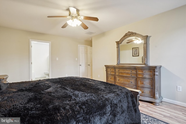 bedroom with ceiling fan, ensuite bathroom, and light wood-type flooring