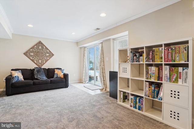 sitting room with crown molding and light carpet