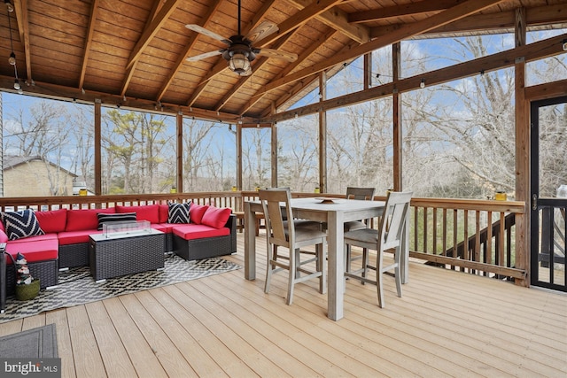 sunroom featuring vaulted ceiling with beams, a wealth of natural light, wooden ceiling, and ceiling fan