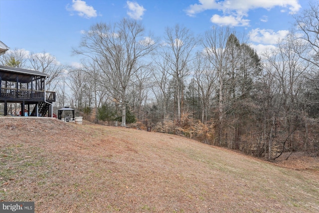 view of yard featuring a deck and a sunroom