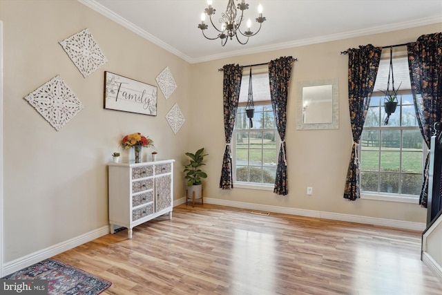 interior space with ornamental molding, a notable chandelier, and light wood-type flooring