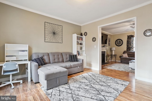 living room with wood-type flooring and ornamental molding