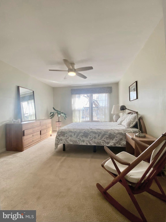 bedroom featuring ceiling fan, carpet floors, and multiple windows