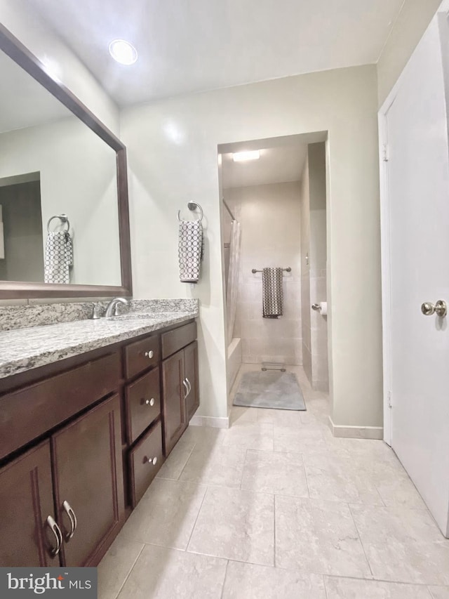 bathroom featuring curtained shower and vanity