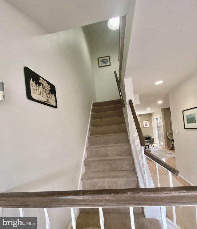 staircase with baseboards and recessed lighting