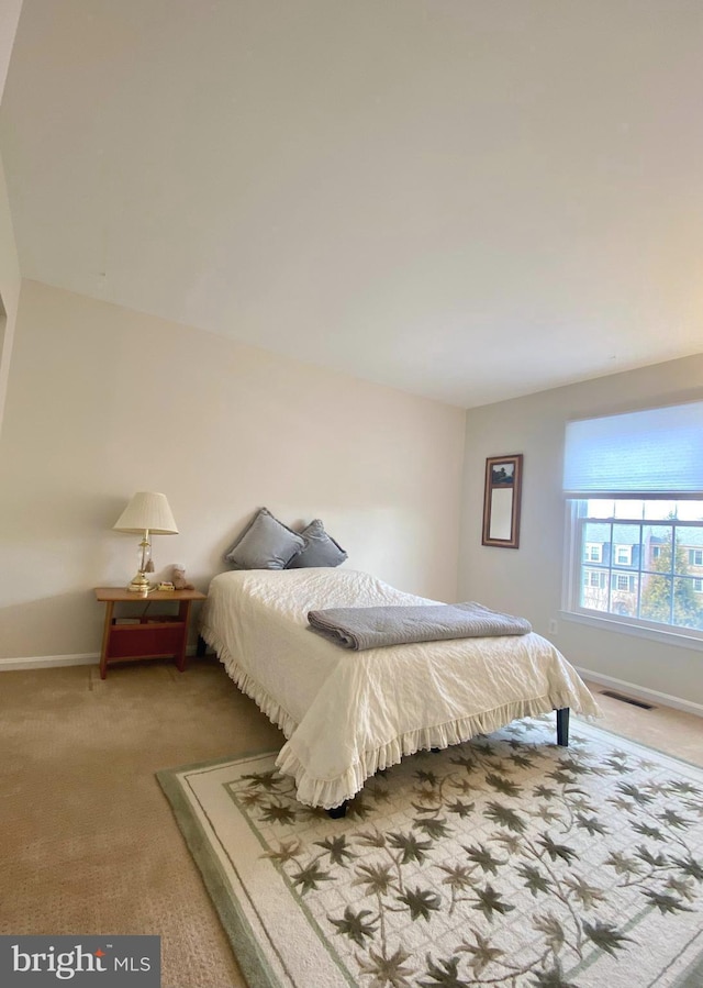 bedroom with carpet flooring, visible vents, and baseboards