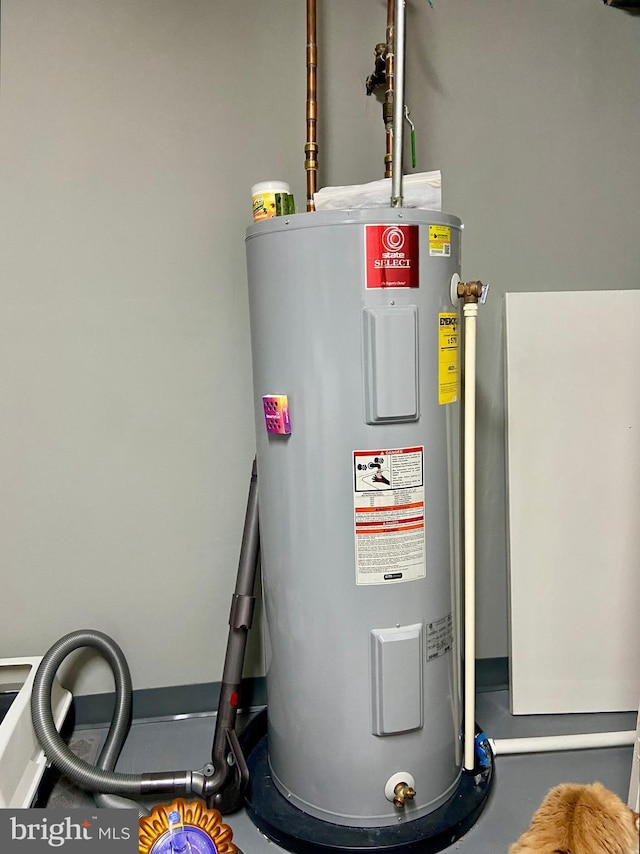 utility room featuring water heater