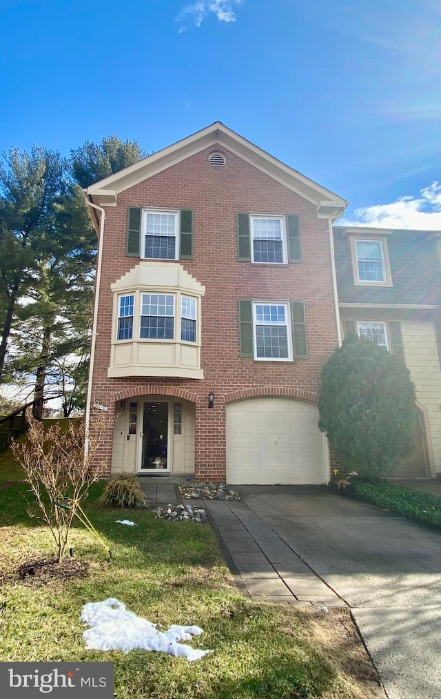 view of front of home featuring an attached garage, concrete driveway, and brick siding