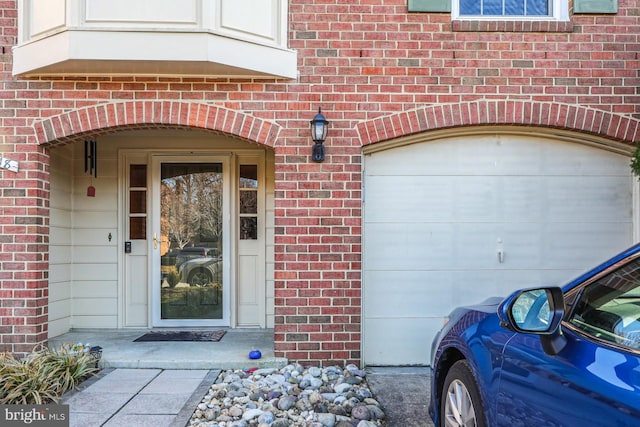 view of exterior entry with brick siding