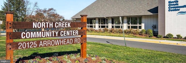 community / neighborhood sign with a lawn