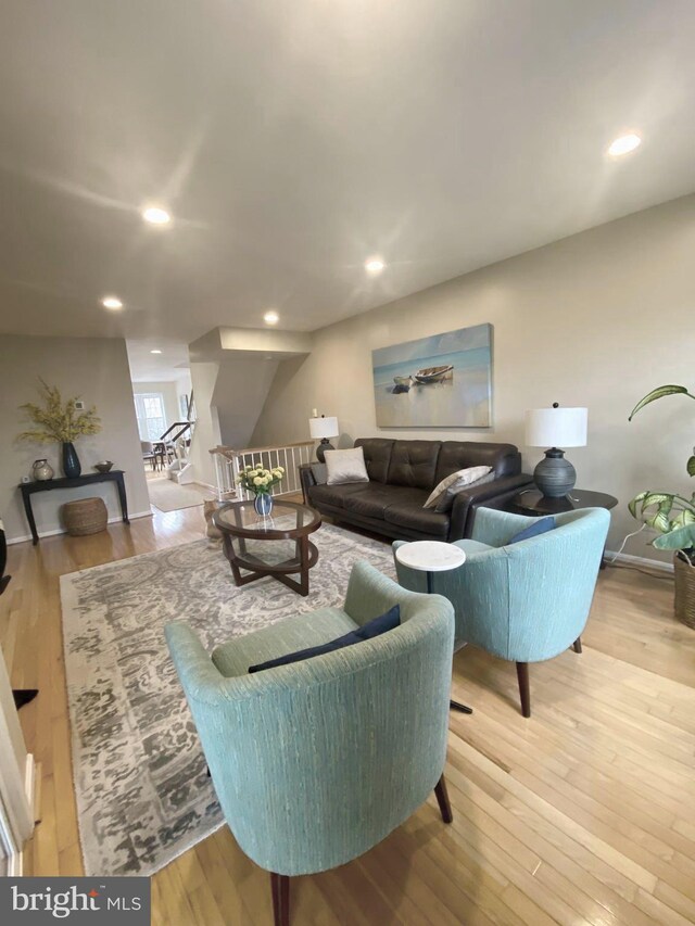 living room with light wood finished floors and recessed lighting