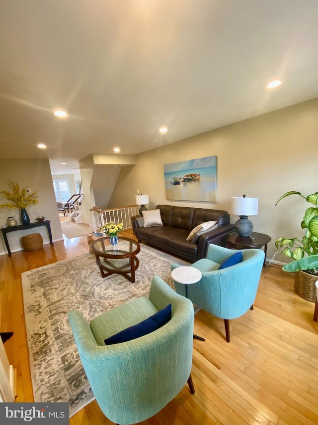 living area featuring light wood finished floors and recessed lighting