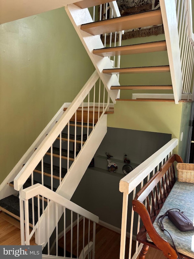 stairway with hardwood / wood-style flooring