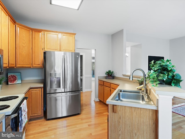 kitchen featuring stainless steel refrigerator with ice dispenser, sink, kitchen peninsula, white range with electric cooktop, and light hardwood / wood-style floors