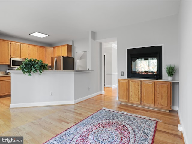 kitchen with stainless steel refrigerator and light wood-type flooring