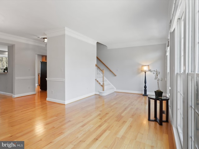 living room featuring crown molding and light hardwood / wood-style floors