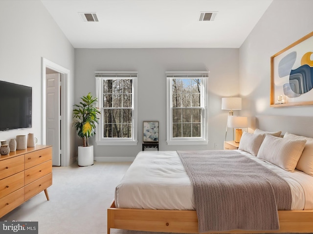 bedroom featuring light carpet