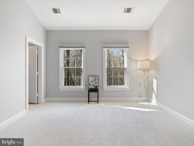 unfurnished room featuring light carpet