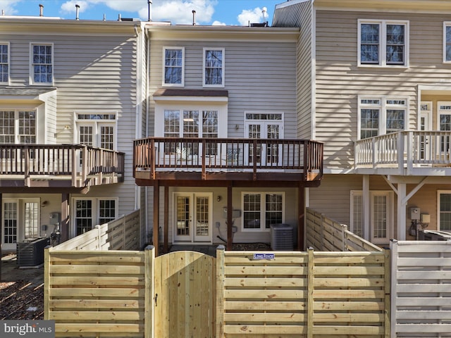 rear view of property with cooling unit