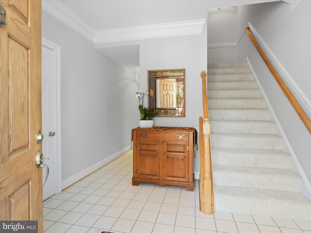 tiled foyer entrance with ornamental molding