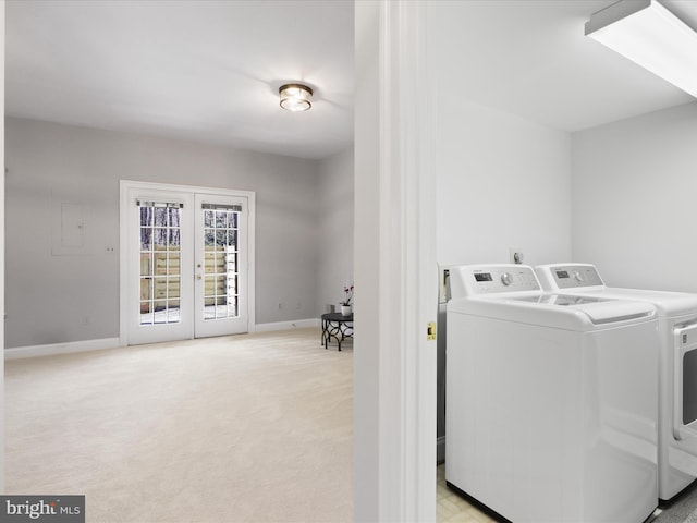 clothes washing area with light colored carpet, independent washer and dryer, and french doors