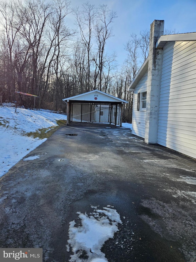 snowy yard featuring a carport