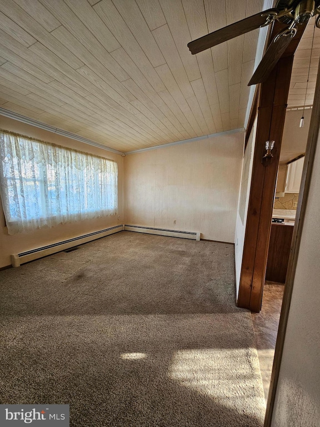 empty room with carpet flooring, wood ceiling, and baseboard heating