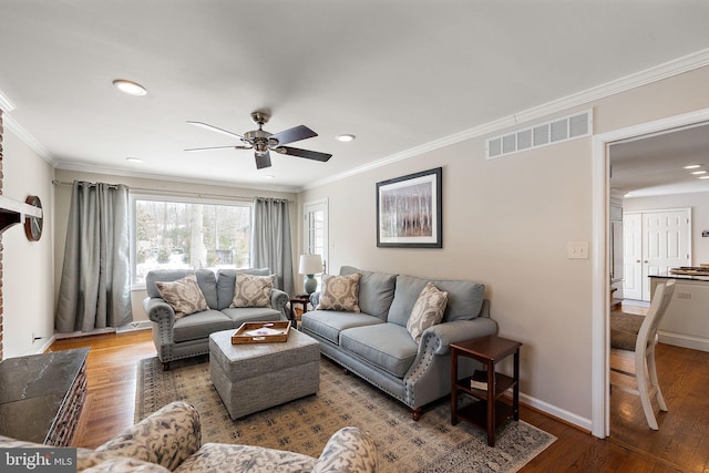 living room featuring wood-type flooring, ornamental molding, and ceiling fan