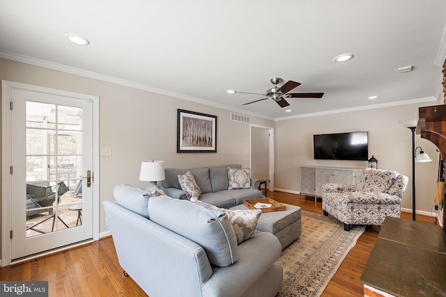 living room with crown molding, hardwood / wood-style flooring, and ceiling fan