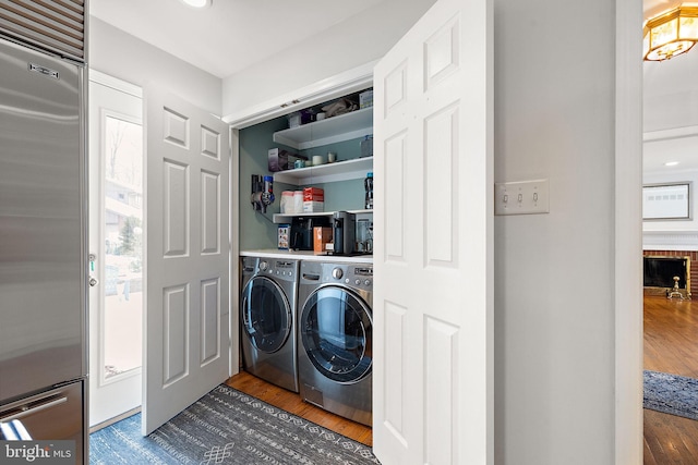 laundry area featuring dark hardwood / wood-style floors and washer and clothes dryer