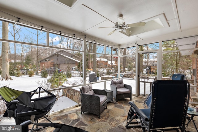 sunroom / solarium featuring ceiling fan