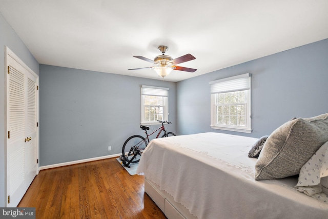 bedroom with hardwood / wood-style flooring, a closet, and ceiling fan