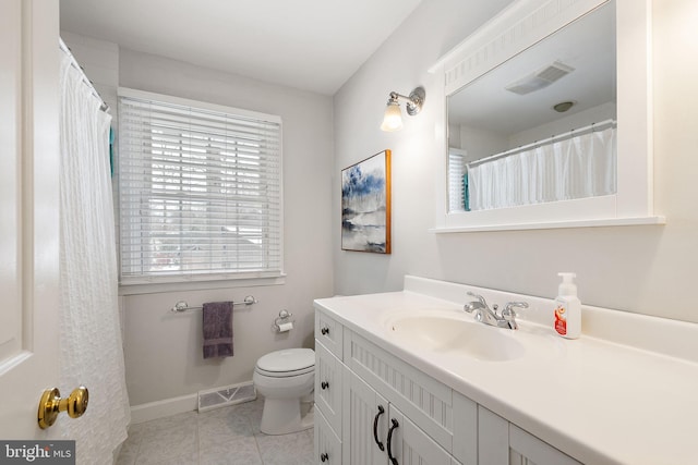 bathroom with tile patterned flooring, vanity, and toilet