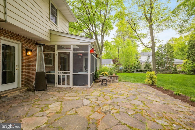 view of patio with a sunroom