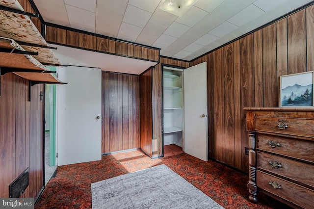 1 Keats Dr, Claymont, DE 19703 - bedroom with dark carpet, a closet, and wood walls