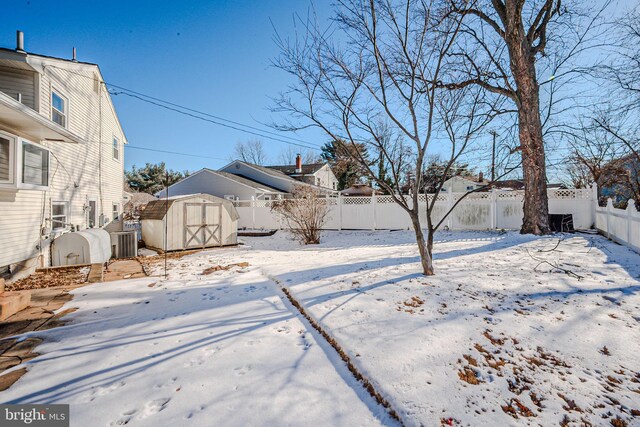 1 Keats Dr, Claymont, DE 19703 - yard layered in snow featuring cooling unit and a storage shed