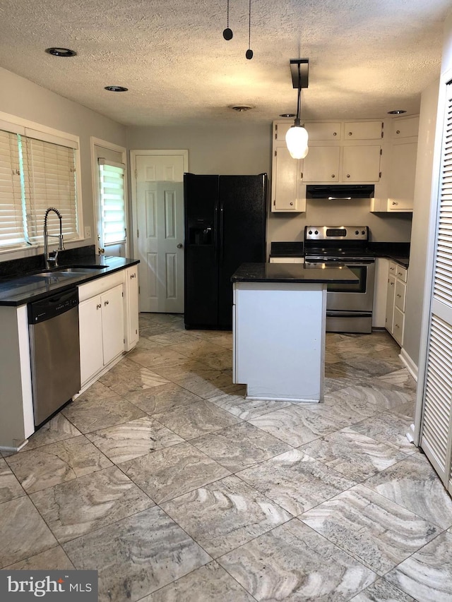 kitchen with pendant lighting, sink, stainless steel appliances, and white cabinets