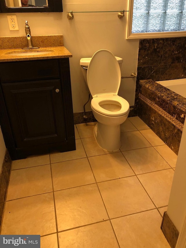 bathroom featuring tile patterned flooring, vanity, and toilet