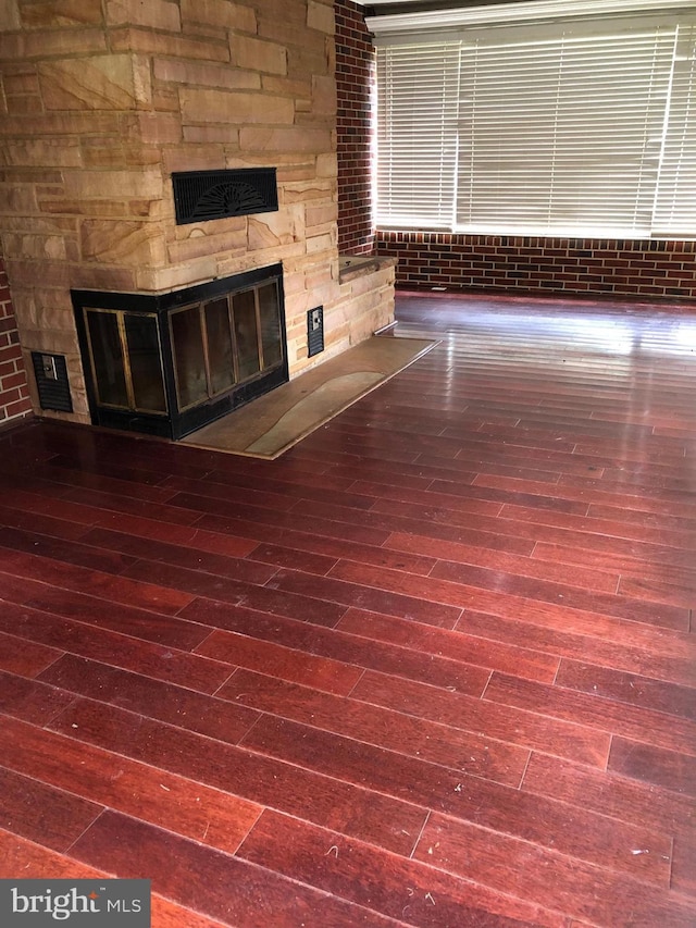 details featuring hardwood / wood-style flooring and a stone fireplace