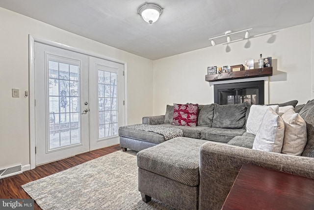 living room with dark wood-type flooring and french doors