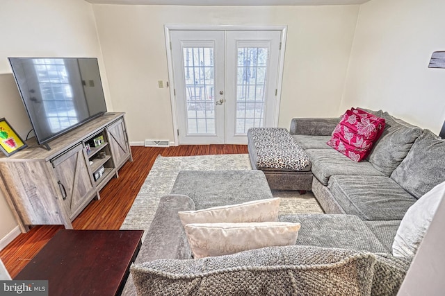 living room featuring dark wood-type flooring and french doors