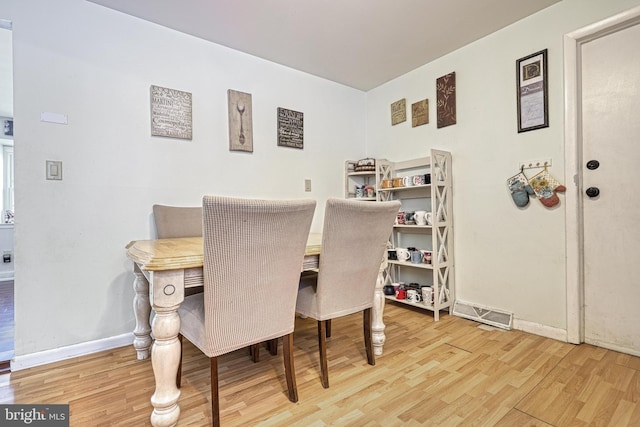 dining space with hardwood / wood-style flooring