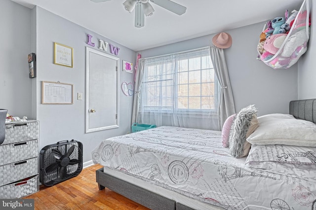 bedroom with hardwood / wood-style floors and ceiling fan