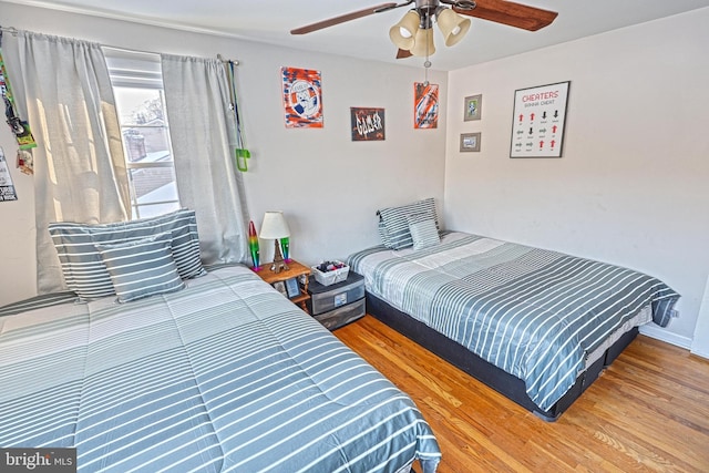 bedroom featuring ceiling fan and wood-type flooring