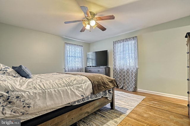 bedroom with ceiling fan and light hardwood / wood-style floors