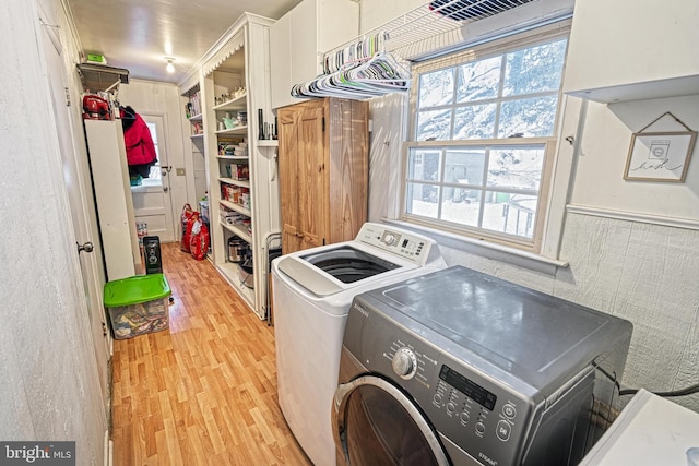 washroom featuring washer and dryer and light hardwood / wood-style flooring