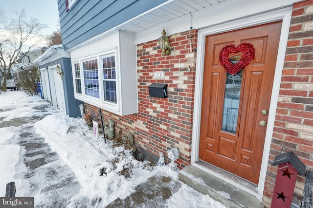 view of snow covered property entrance